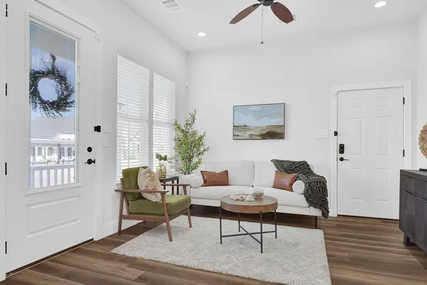 a living room with furniture and wooden floor