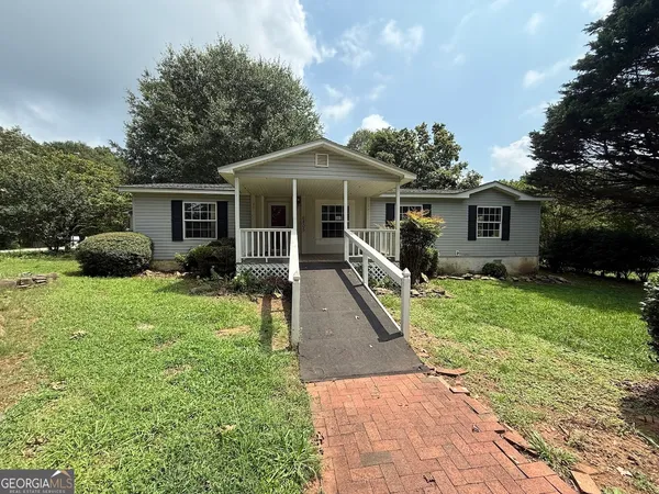 a front view of house with a garden