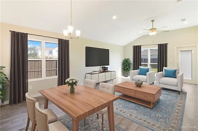 a living room with furniture a chandelier and a flat screen tv