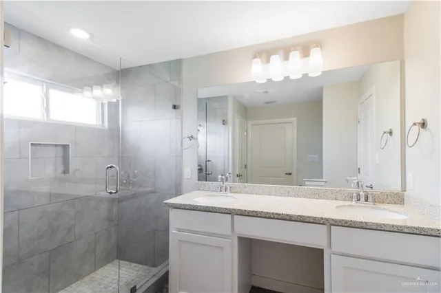 a bathroom with a sink double vanity and a mirror