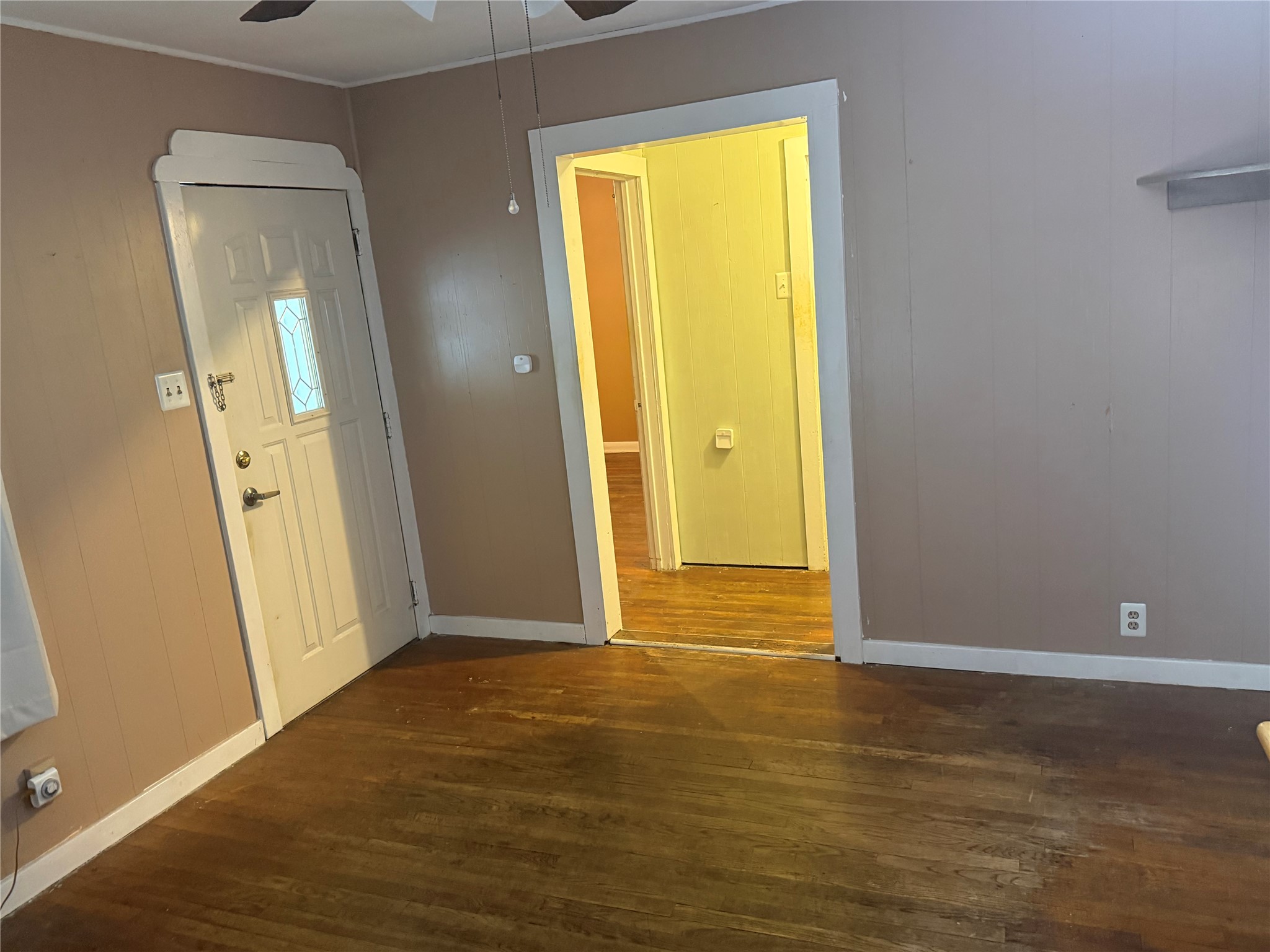 5702 Duval Street Austin, TX 78752 - Photo 10 of 31 Hardwood flooring complements paneled walls in this interior space