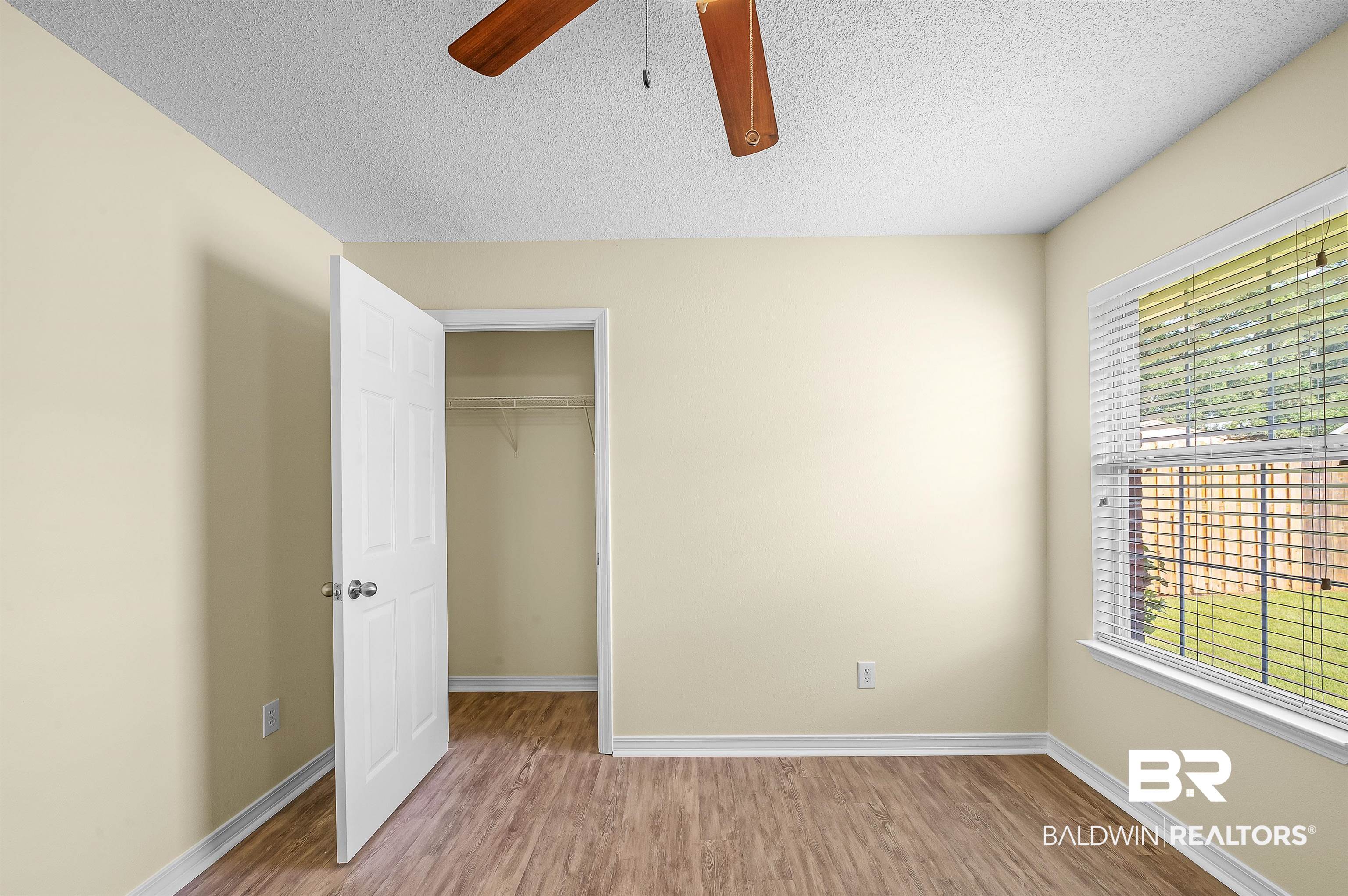 12443 Venice Boulevard Foley, AL 36535 - Photo 54 of 59 Unfurnished bedroom featuring a textured ceiling, ceiling fan, a closet, and light hardwood / wood-style floors