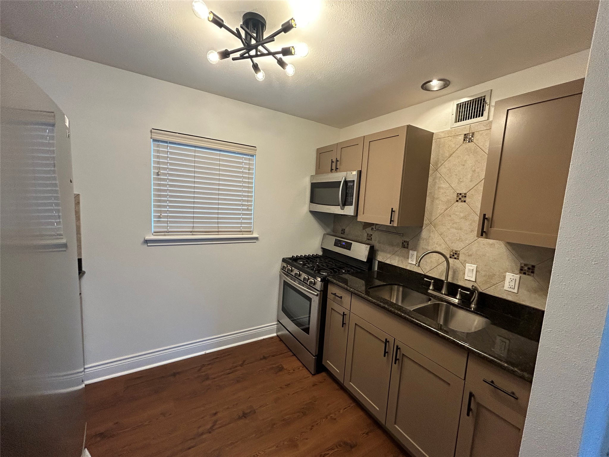 5612 Grover Avenue, Unit 101 Austin, TX 78756 - Photo 12 of 15 a kitchen with a sink appliances and cabinets