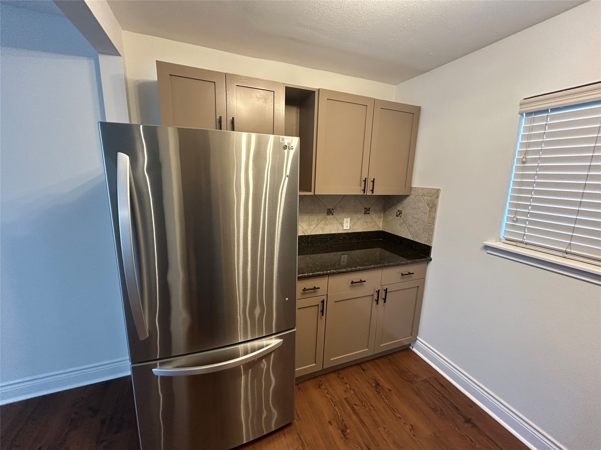 5612 Grover Avenue, Unit 101 Austin, TX 78756 - Photo 13 of 15 a kitchen with stainless steel appliances granite countertop a refrigerator and a sink