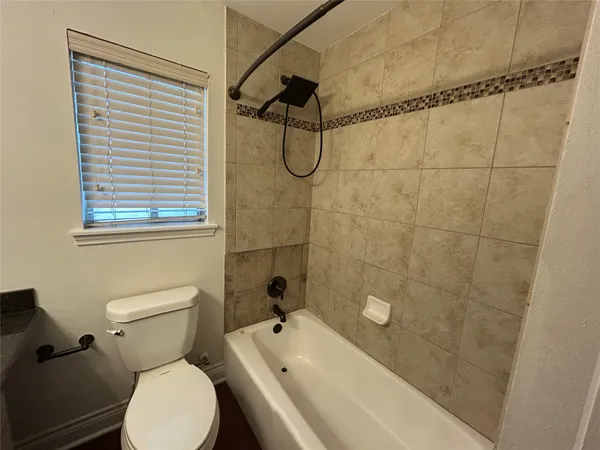 a bathroom with a toilet sink and shower