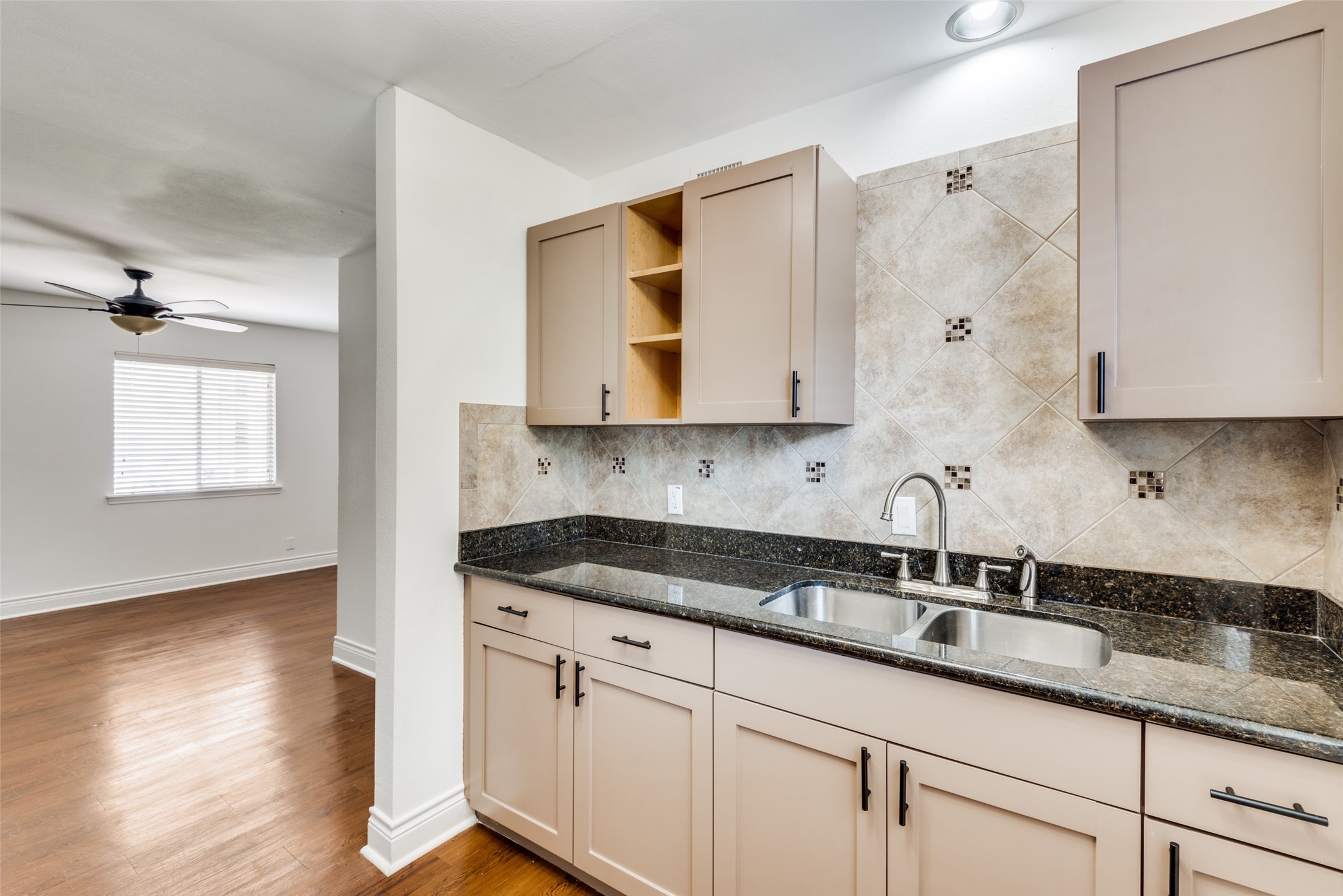 5612 Grover Avenue, Unit 101 Austin, TX 78756 - Photo 3 of 15 a kitchen with granite countertop white cabinets and a sink