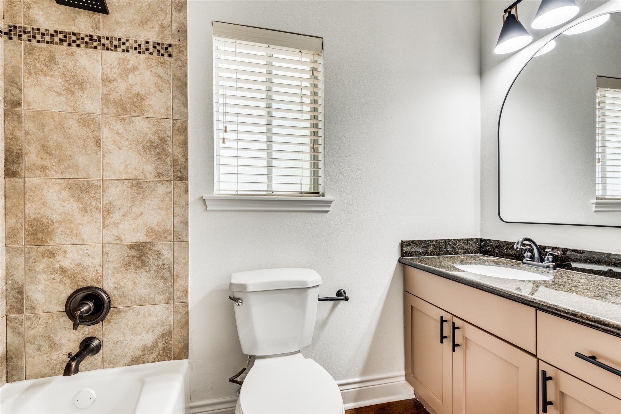 5612 Grover Avenue, Unit 101 Austin, TX 78756 - Photo 6 of 15 a bathroom with a granite countertop toilet sink and mirror