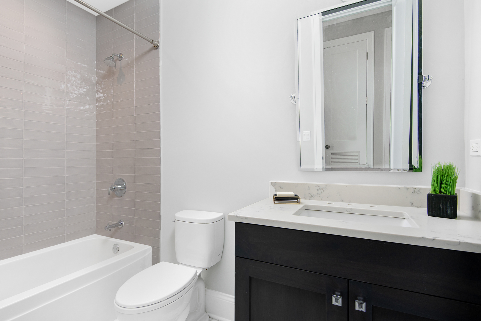 2649 North Racine Avenue, Unit 101 Chicago, IL 60614 - Photo 12 of 13 a bathroom with a sink a toilet and bathtub