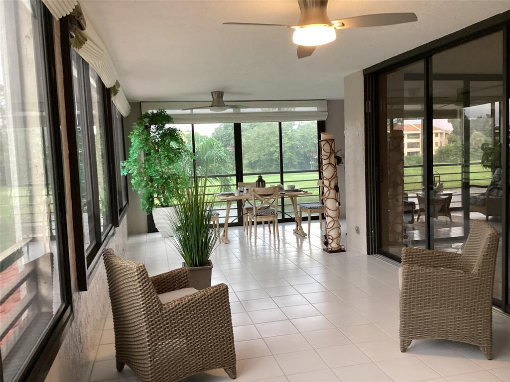 7567 Imperial Drive, Unit 201 Boca Raton, FL 33433 - Photo 15 of 41 a living room with furniture and a large window