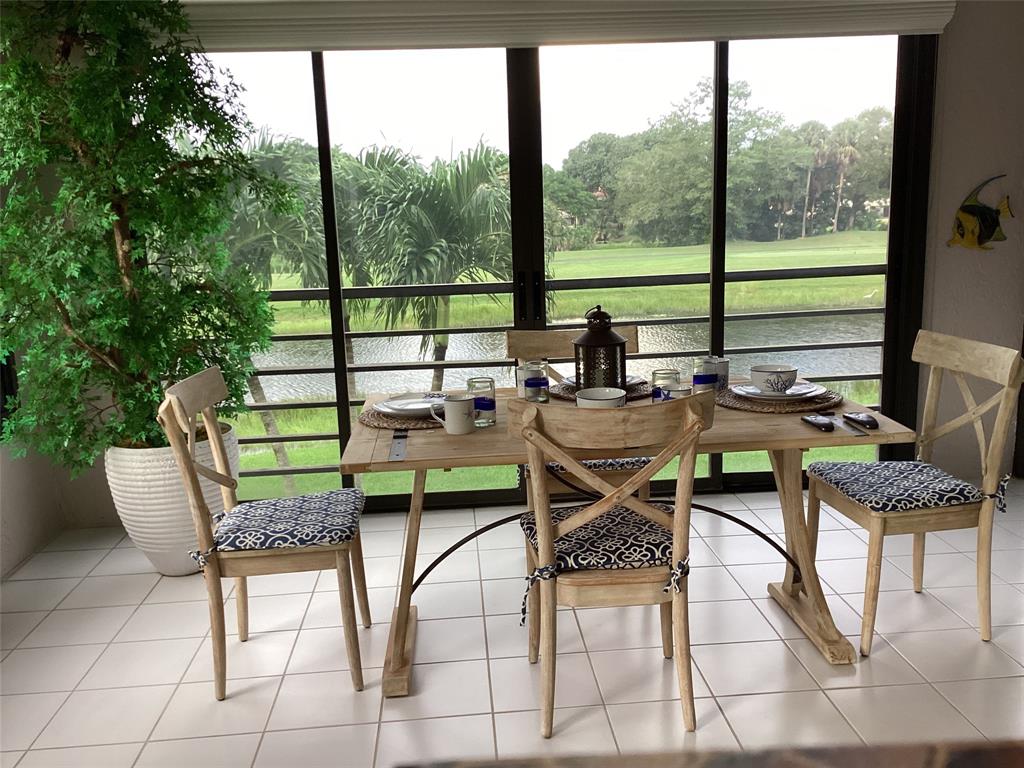 7567 Imperial Drive, Unit 201 Boca Raton, FL 33433 - Photo 18 of 41 a living room with furniture and a floor to ceiling window