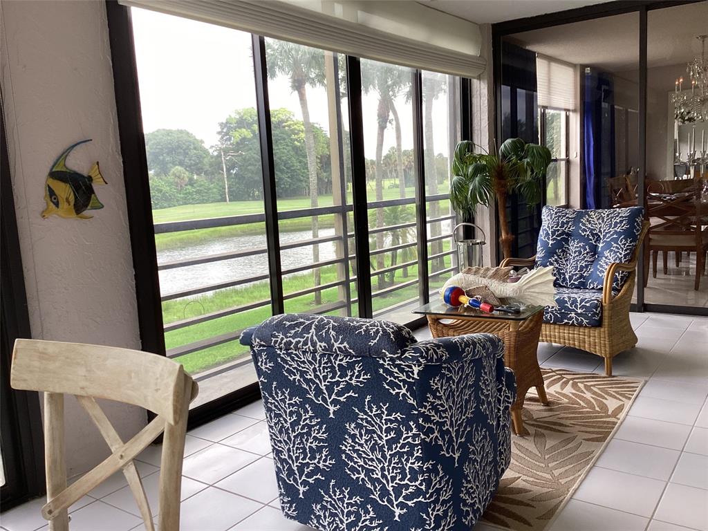 7567 Imperial Drive, Unit 201 Boca Raton, FL 33433 - Photo 20 of 41 a living room with furniture and a floor to ceiling window