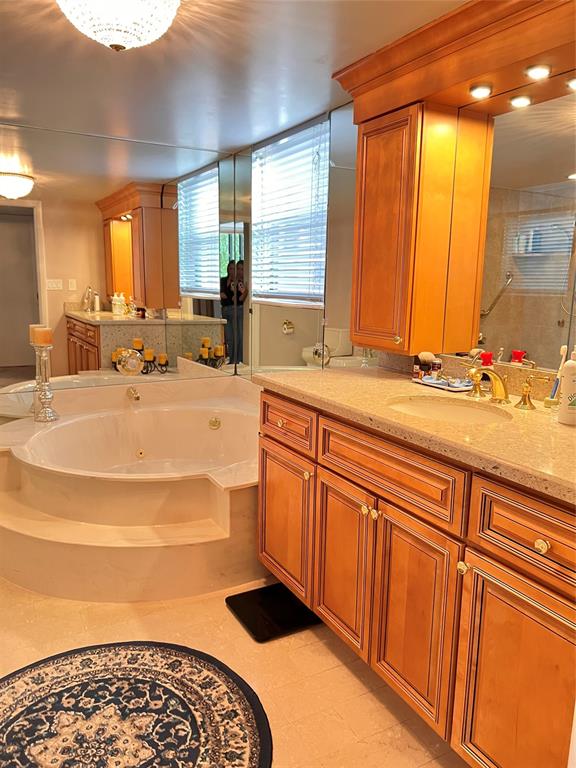 7567 Imperial Drive, Unit 201 Boca Raton, FL 33433 - Photo 27 of 41 a bathroom with a sink a mirror and a bathtub
