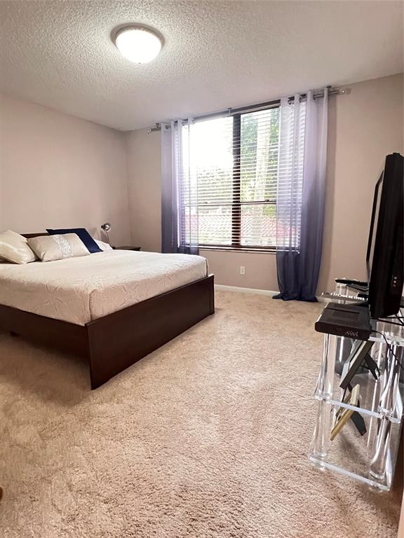 7567 Imperial Drive, Unit 201 Boca Raton, FL 33433 - Photo 29 of 41 a bedroom with a bed and a window