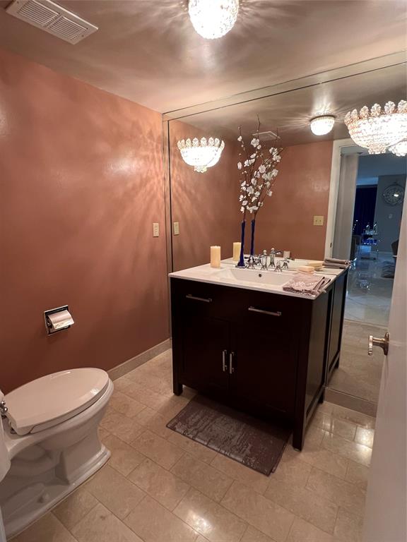 7567 Imperial Drive, Unit 201 Boca Raton, FL 33433 - Photo 30 of 41 a bathroom with a sink a toilet and a mirror