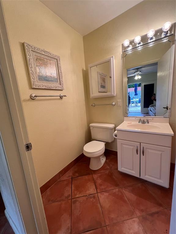 7567 Imperial Drive, Unit 201 Boca Raton, FL 33433 - Photo 33 of 41 a bathroom with a sink mirror vanity and toilet