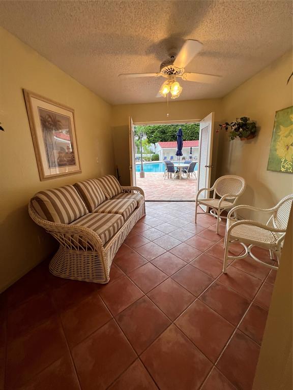7567 Imperial Drive, Unit 201 Boca Raton, FL 33433 - Photo 35 of 41 a living room with furniture a lamp and a chandelier