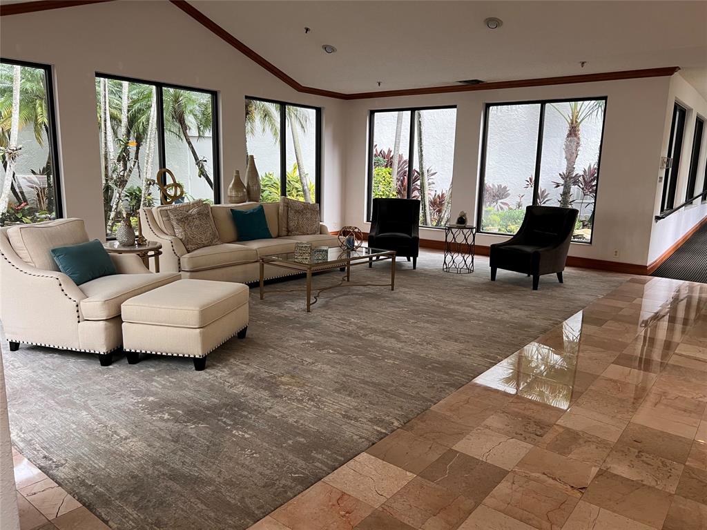 7567 Imperial Drive, Unit 201 Boca Raton, FL 33433 - Photo 40 of 41 a living room with furniture and large windows