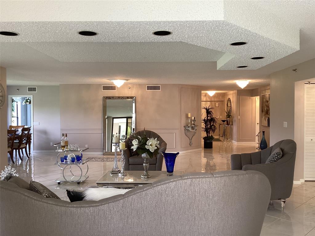 7567 Imperial Drive, Unit 201 Boca Raton, FL 33433 - Photo 4 of 41 a view of a living room and dining room