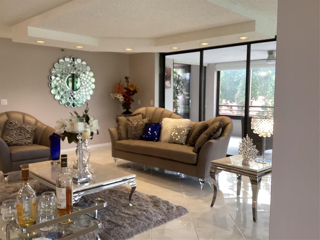 7567 Imperial Drive, Unit 201 Boca Raton, FL 33433 - Photo 5 of 41 a living room with furniture and a large window