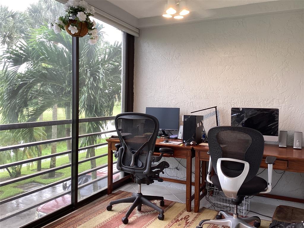 7567 Imperial Drive, Unit 201 Boca Raton, FL 33433 - Photo 9 of 41 a view of a workspace with furniture and a window