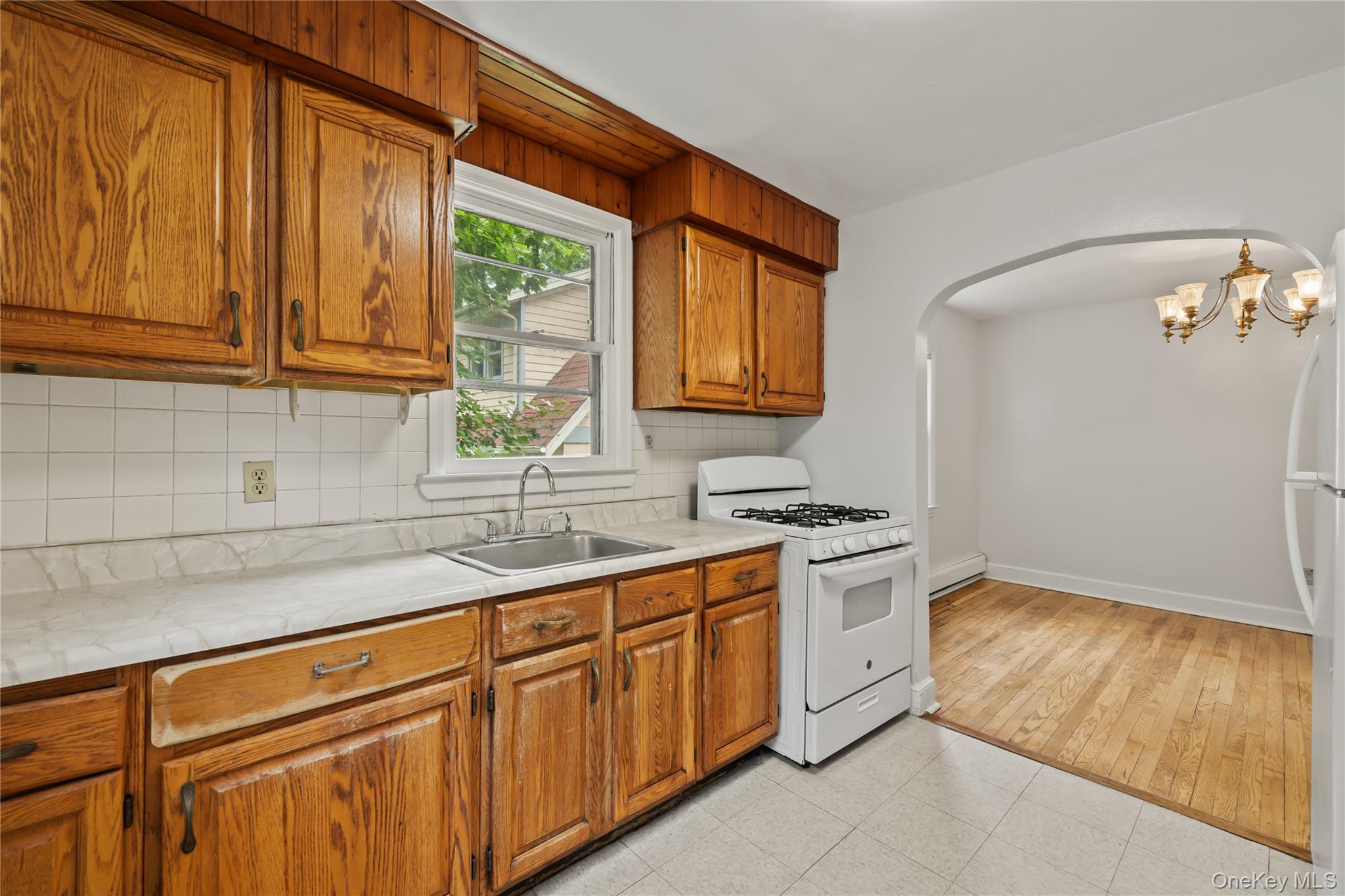 281-283 Old Haverstraw Road Congers, NY 10920 - Photo 10 of 41 a kitchen with stainless steel appliances granite countertop a sink a stove and a wooden cabinets