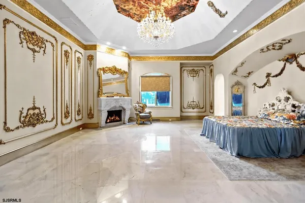 a bedroom with a bed and a chandelier