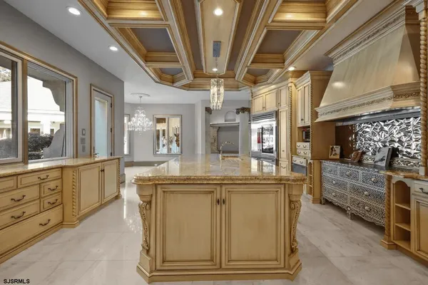 a view of living room kitchen with stainless steel appliances granite countertop furniture and a fireplace