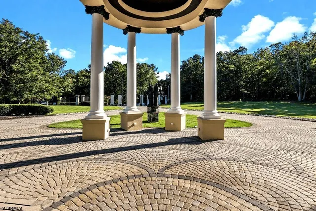 a view of a patio with a table chairs and a small yard