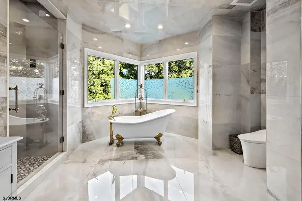 a bath room with a toilet a sink and a bath tub