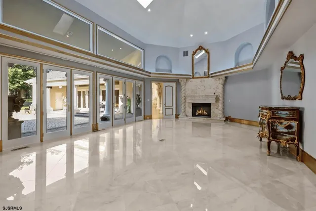 a view of livingroom with furniture fireplace and window