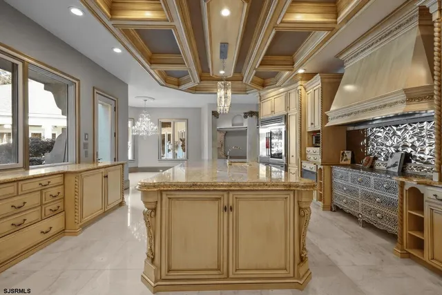 a view of living room kitchen with stainless steel appliances granite countertop furniture and a fireplace