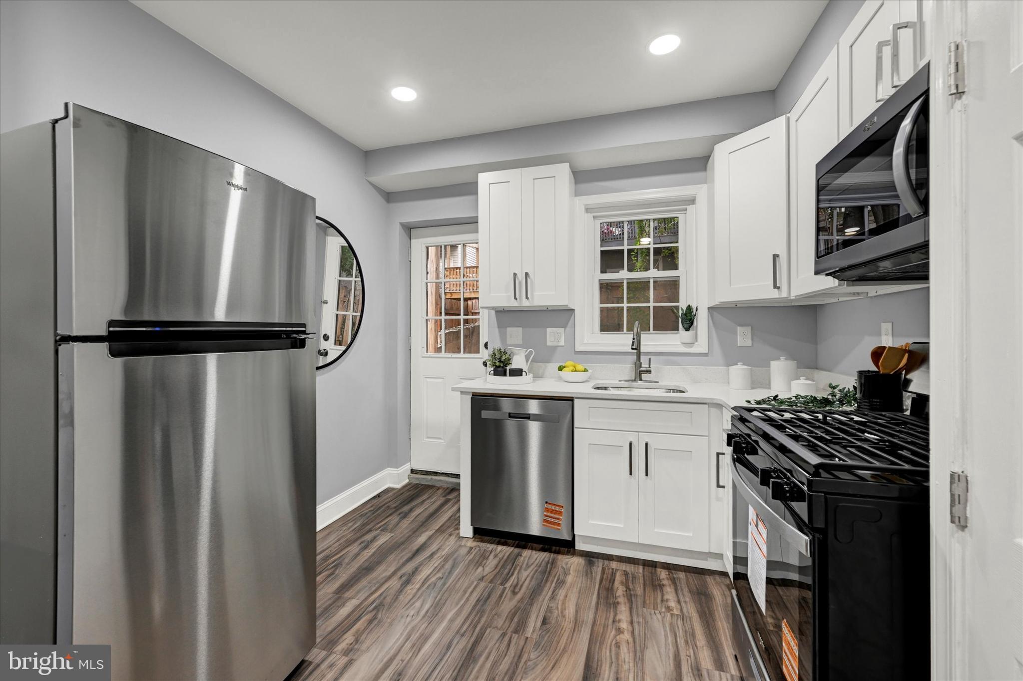 864 Lemmon Street Baltimore, MD 21201 - Photo 8 of 18 a kitchen with stainless steel appliances a refrigerator sink and stove