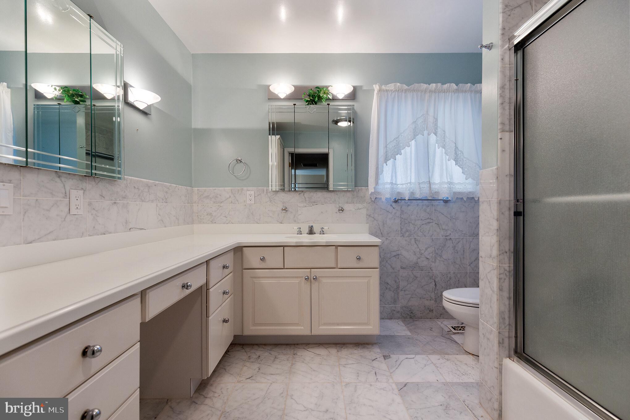 10756 Sawpit Cove Road Lusby, MD 20657 - Photo 33 of 39 Hall bathroom with marble floor, wainscoting