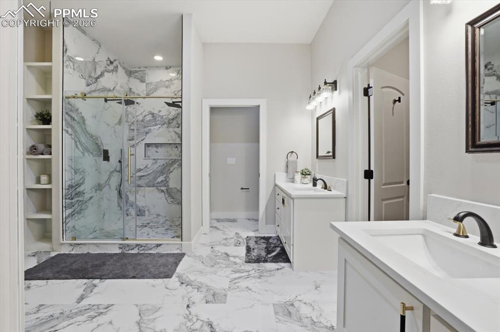 15755 Fool's Gold Lane Colorado Springs, CO 80921 - Photo 20 of 50 a bathroom with a sink vanity mirror and shower