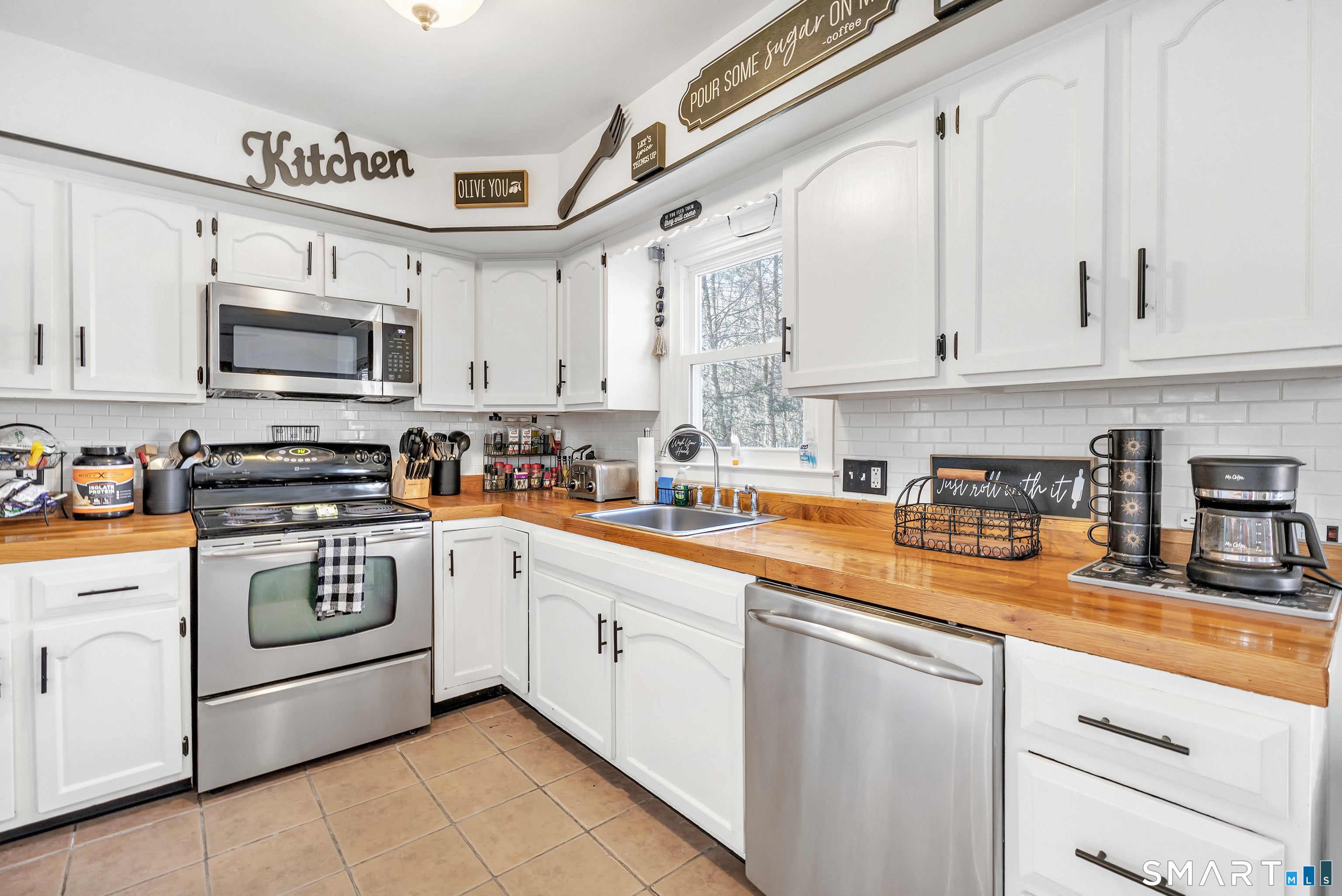 52 Cook Lane Beacon Falls, CT 06403 - Photo 10 of 24 a kitchen with stainless steel appliances granite countertop a sink and cabinets
