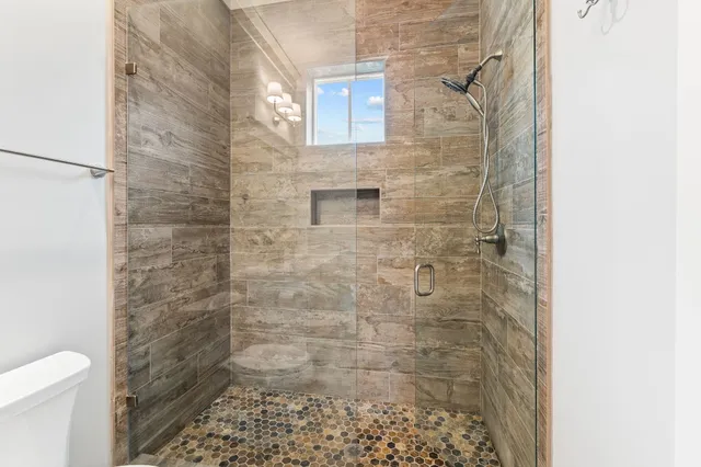 a bathroom with a toilet sink and mirror