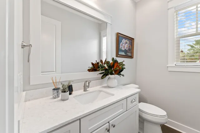 a spacious bedroom with a bed mirror and window