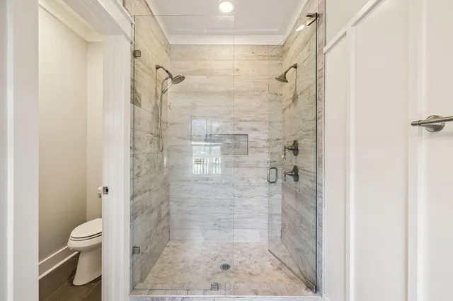 a bedroom with furniture and a large window