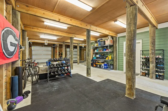 a view of a house with a big yard and large trees
