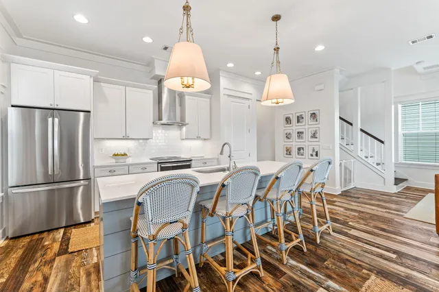 a kitchen with granite countertop a refrigerator and microwave
