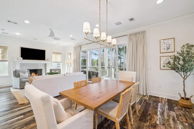 a kitchen with kitchen island stainless steel appliances a dining table and chairs