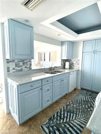 a kitchen with a sink a stove a refrigerator and cabinets