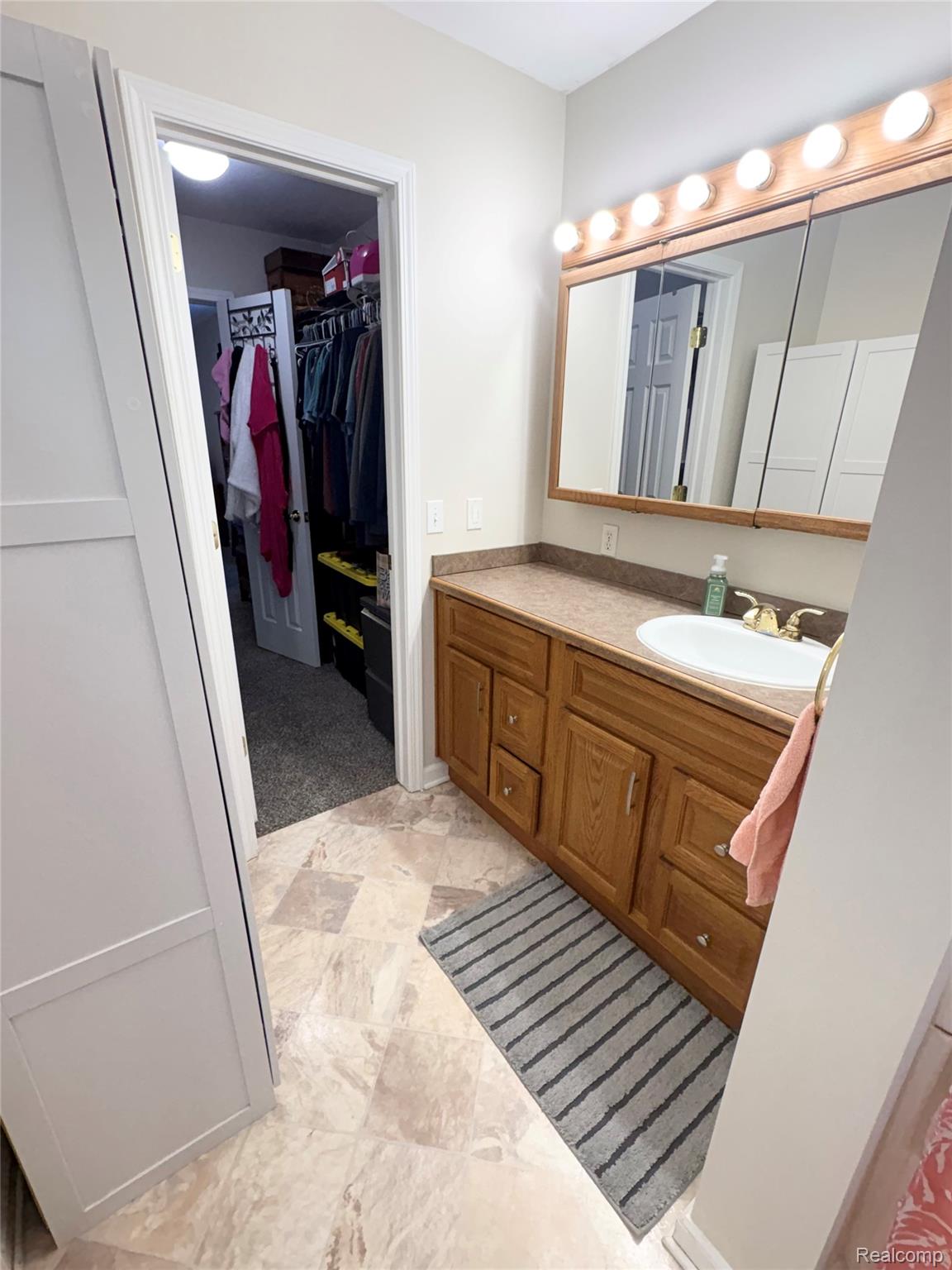 2230 North Center Road Burton, MI 48509 - Photo 12 of 21 Bathroom featuring a spacious closet and vanity