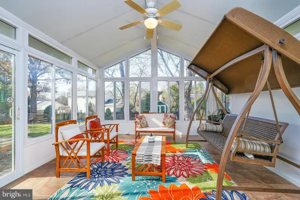 a view of a house with sitting area and garden