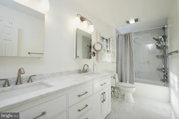 a bathroom with a glass shower door