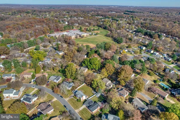 a view of a pathway of a building with large trees
