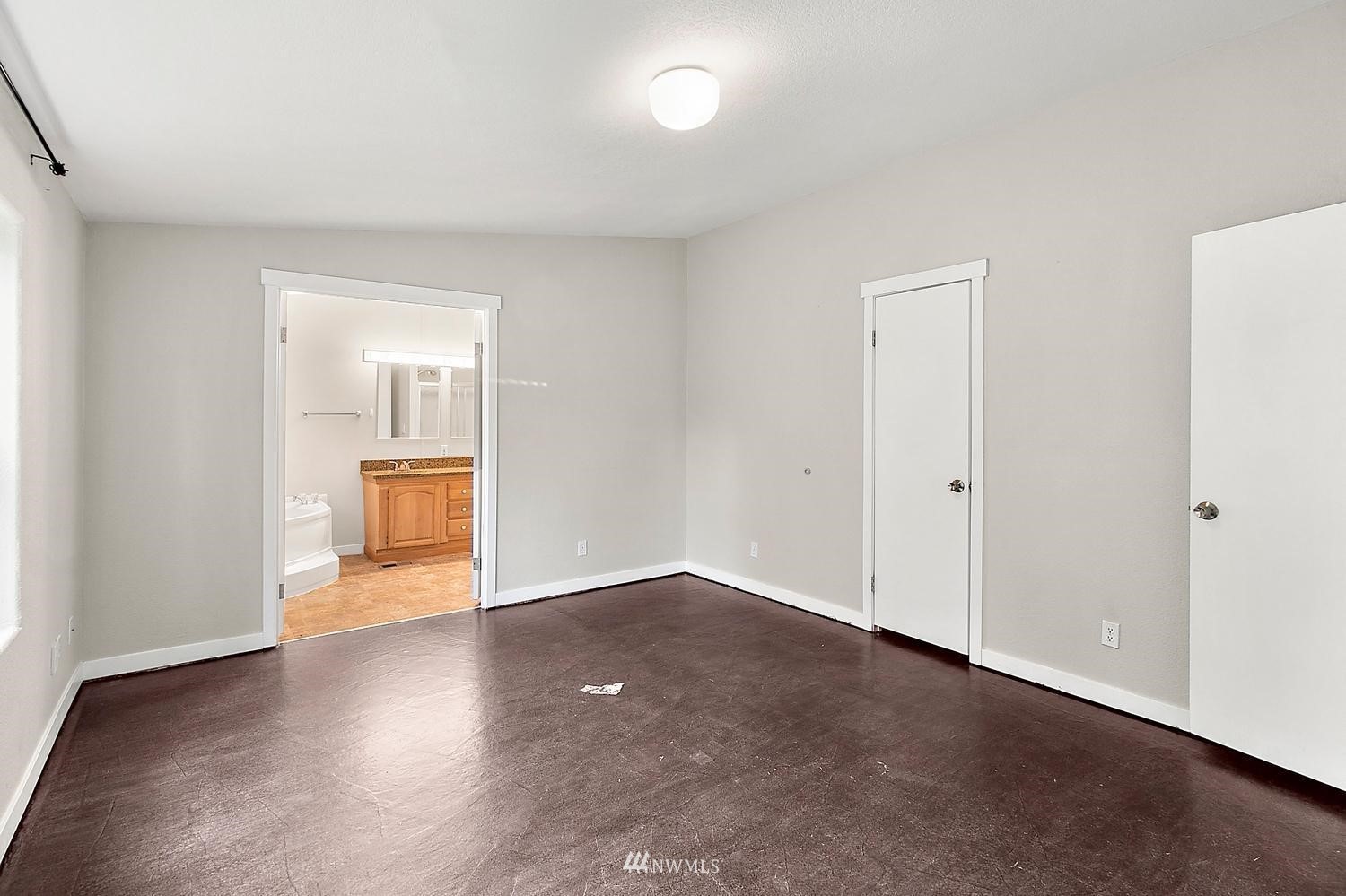 5038 186th Lane Southwest Rochester, WA 98579 - Photo 20 of 36 an empty room with wooden floor and bathroom view