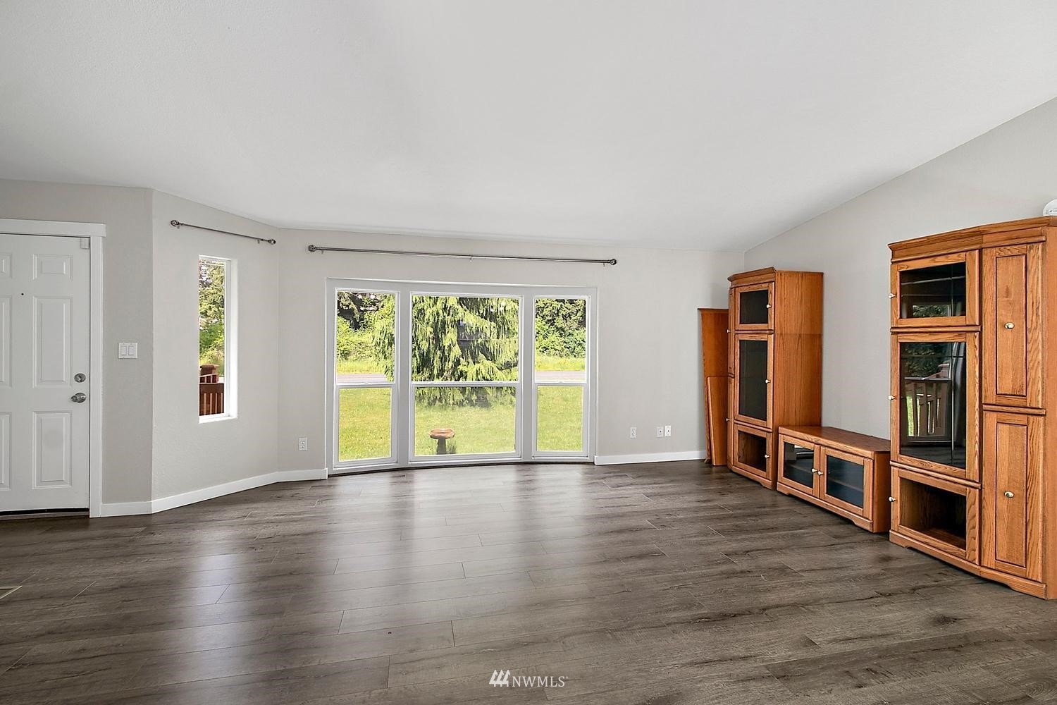 5038 186th Lane Southwest Rochester, WA 98579 - Photo 4 of 36 a view of an empty room with wooden floor and a window