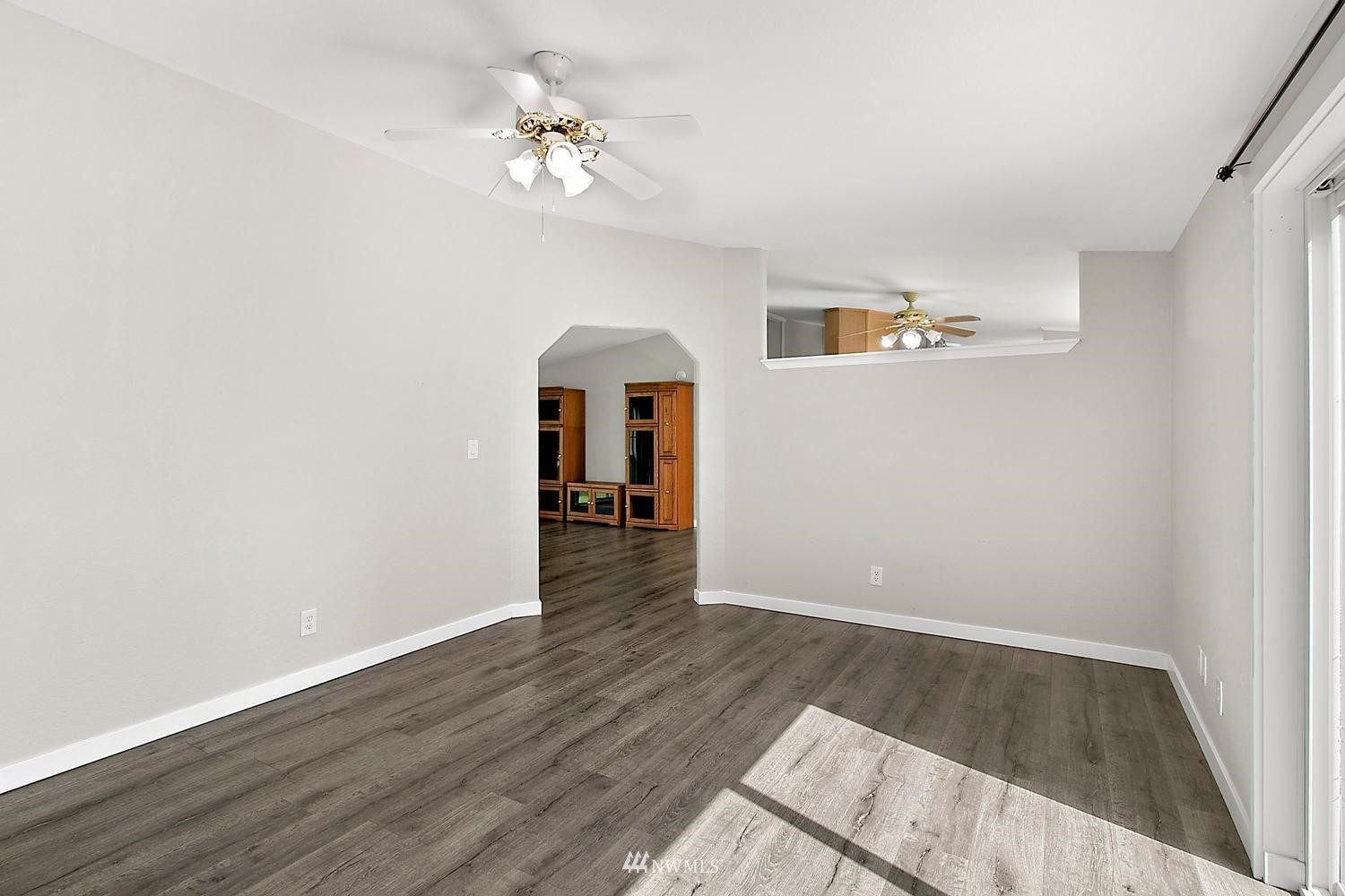 5038 186th Lane Southwest Rochester, WA 98579 - Photo 7 of 36 a view of an empty room with wooden floor