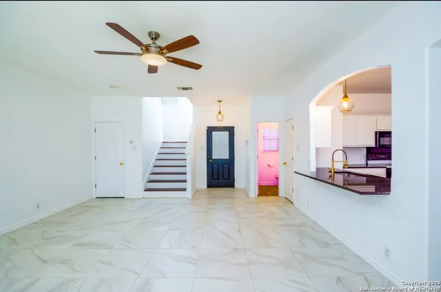 a view of a livingroom with furniture and staircase